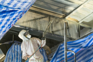 Applying spray foam insulation.